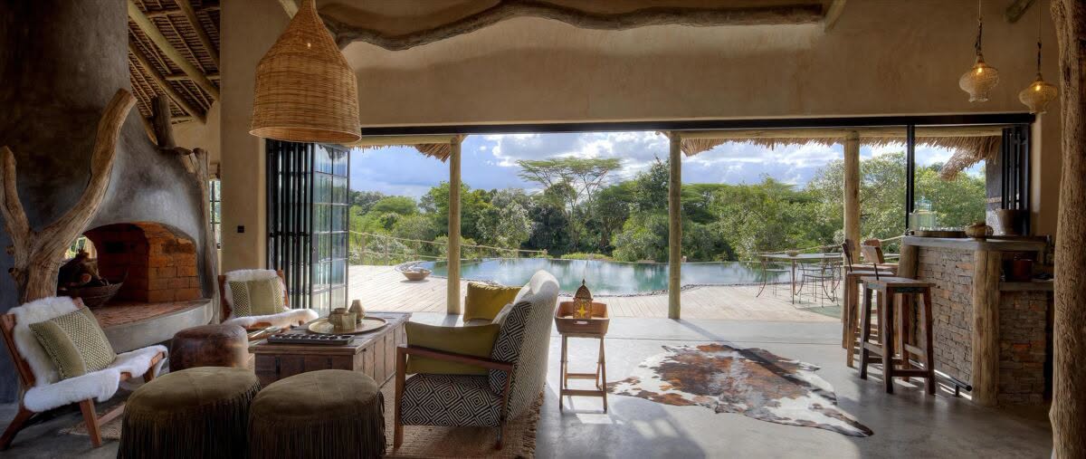 Warm private lounge opening onto an infinity pool