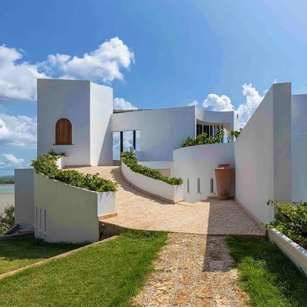 White coastal villa beneath a blue sky
